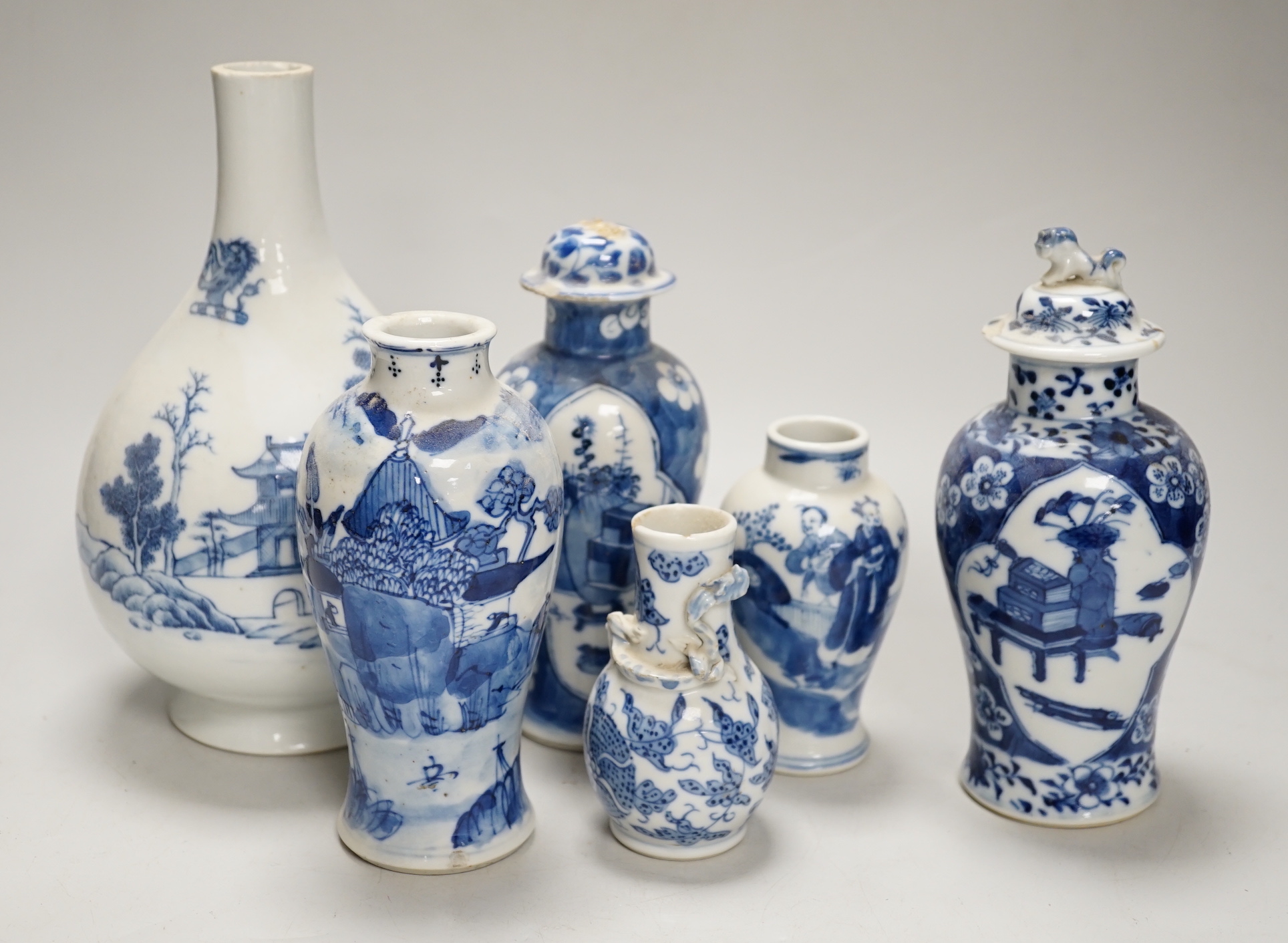 A Chinese armorial blue and white bottle vase, Qianlong/Jiaqing period, and five assorted 19th century Chinese blue and white vases, tallest 20cm; faults